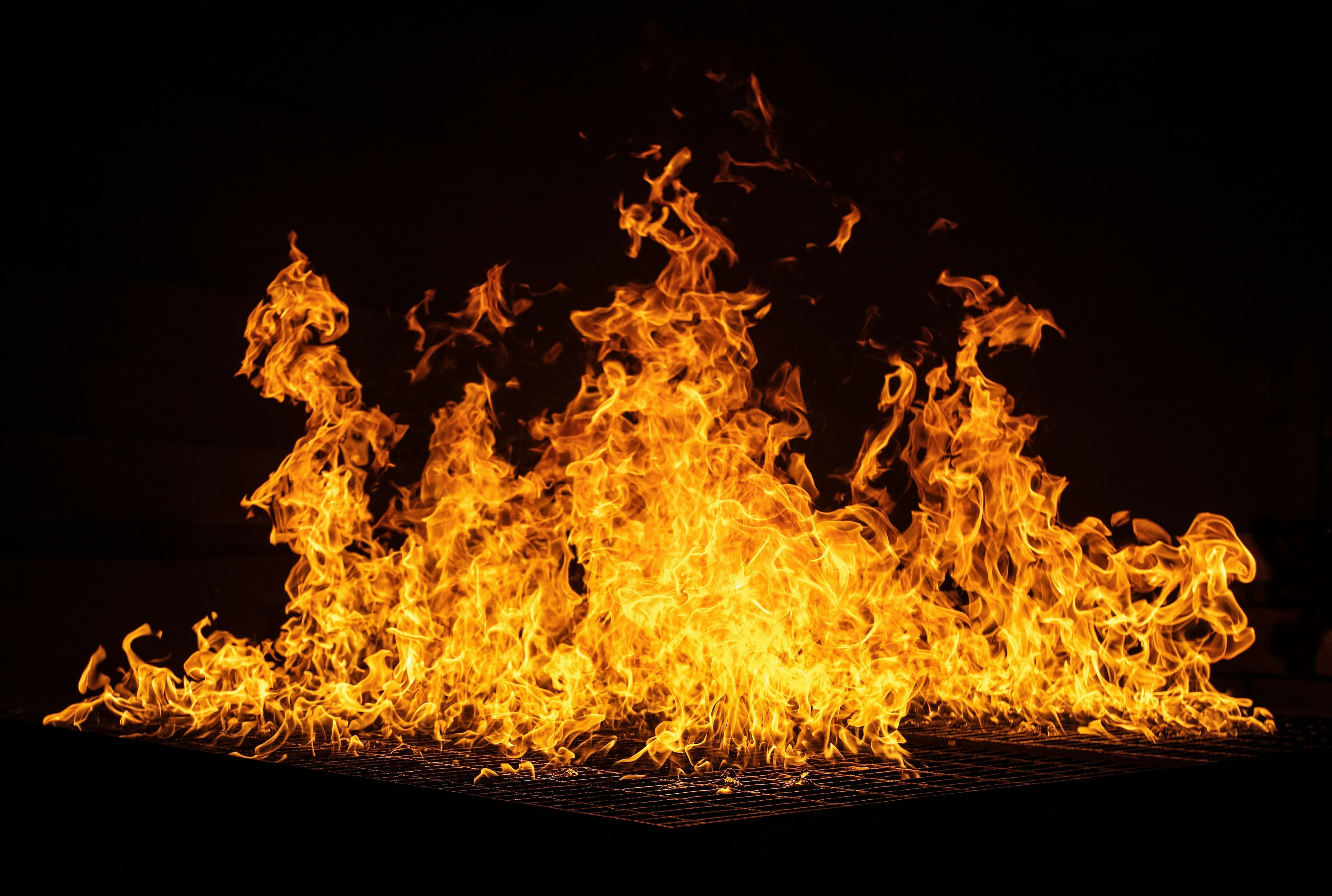 People gathered around a glowing fire at dusk